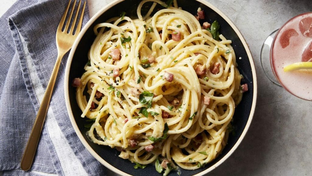 Silky Bucatini Carbonara Recipe - Cooking Fanatic - feastfulcuisine.com